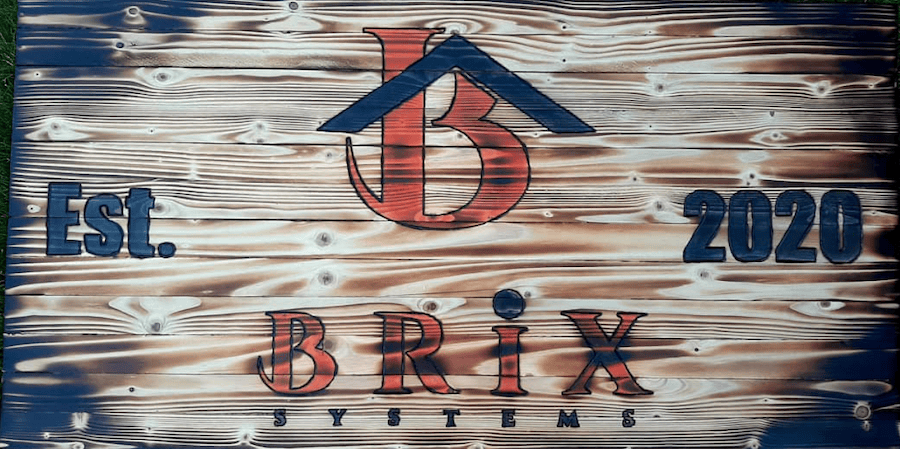 Wooden sign that says Brix Systems Established in 2020