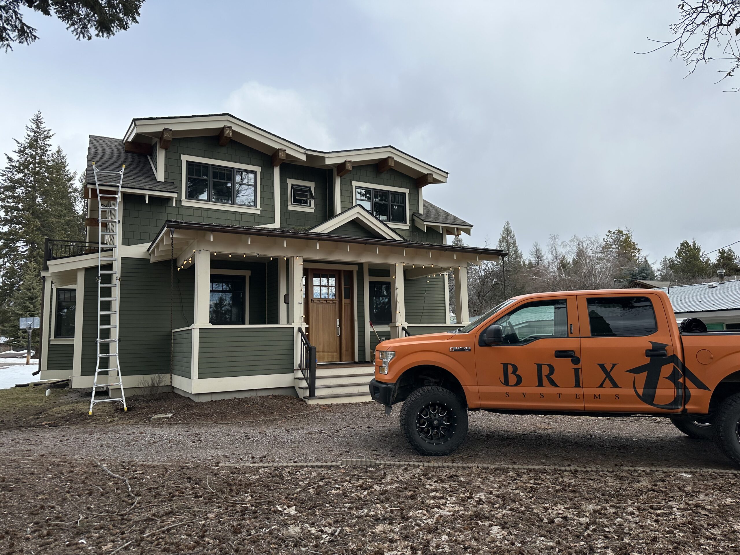 Brix Systems Roofing Company Truck in front of a house