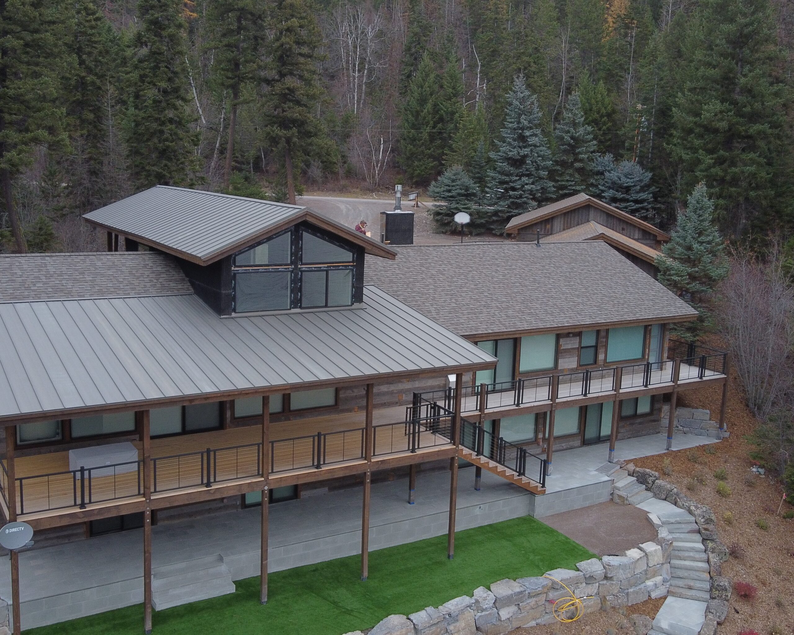 modern house in the flathead valley with a shingle and metal roof