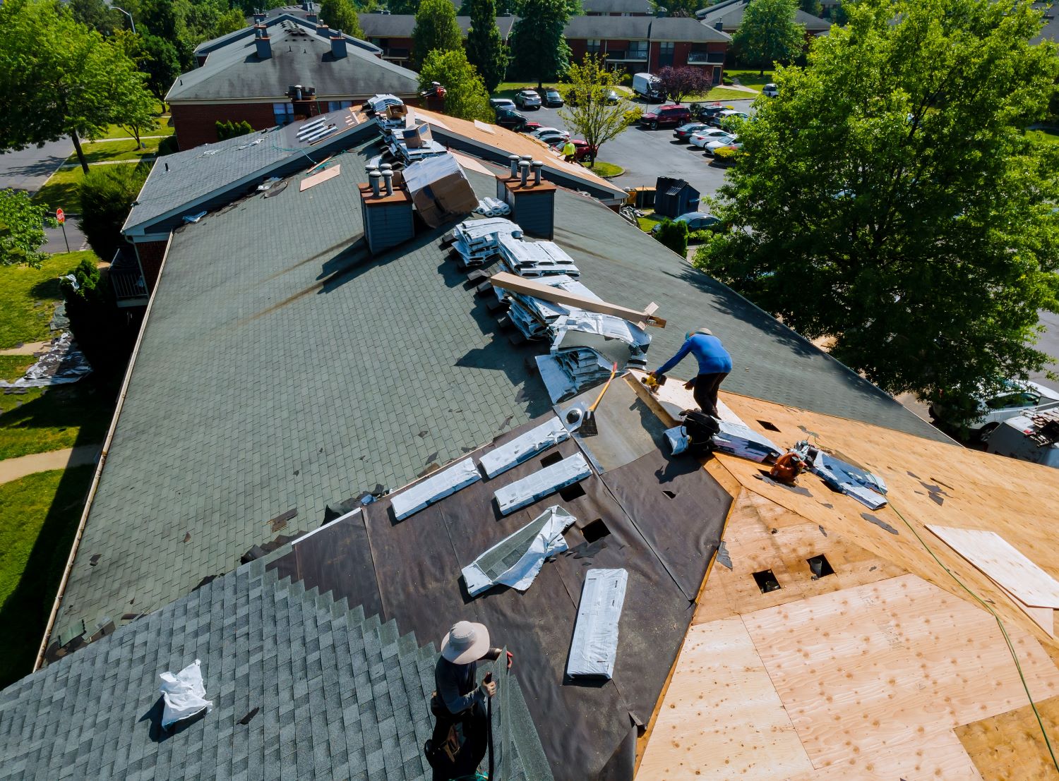 Roofing Contractor installing new shingle roofing on an apartment complex