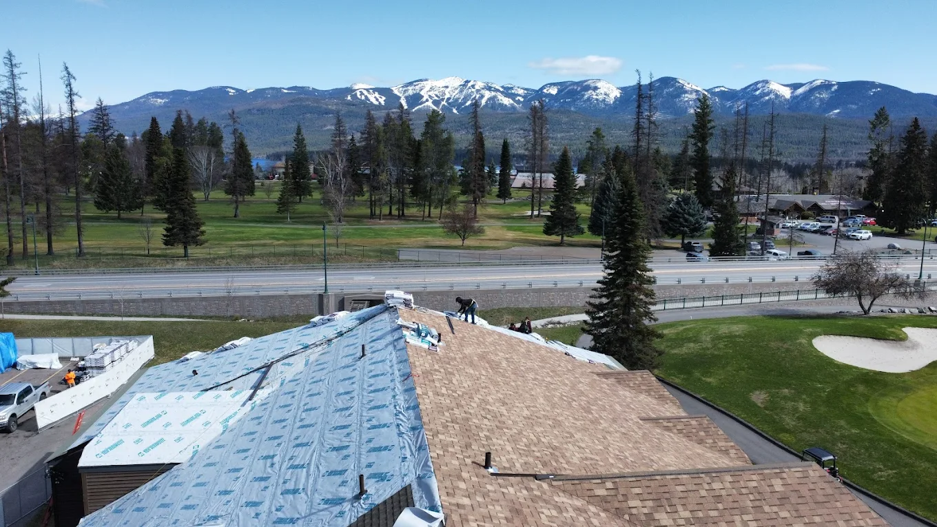 Roofing Contractors installing a new shingle roof in Montana