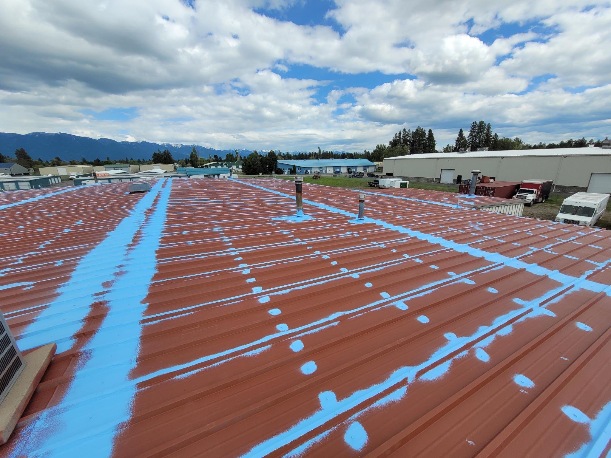 Fluid applied roofing process on a commercial metal roof in montana