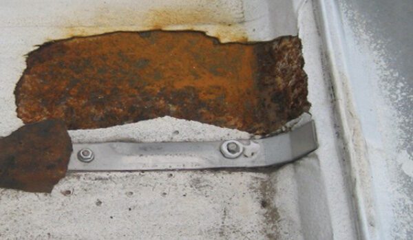 A Polyester fabric and/or seam tape that has failed... allowing moisture to trap, causing rust damage to the roof.